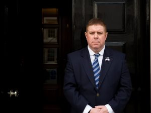 Inner Temple Porter stood in front of black door