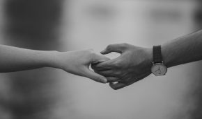 Black and white image of hands holding