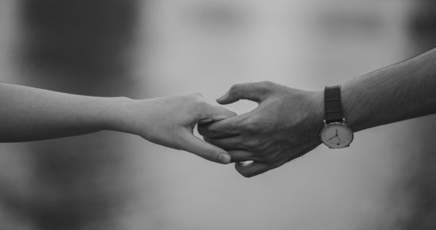 Black and white image of hands holding