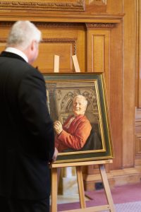 A person admires a portrait of the Master of the Temple