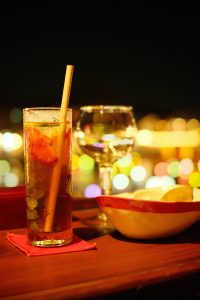Moodily lit cocktails with out of focus lights in the background