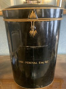 black wig tin, with gold trim and Ian Percival Esq QC printed on the front