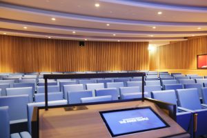 View of the Inner Temple Lecture Theatre from the lectern. An inset screen has the Inn's logo.