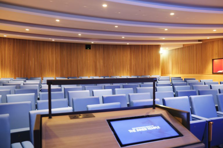View of the Inner Temple Lecture Theatre from the lectern. An inset screen has the Inn's logo.