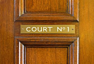 Sign on wooden door reading "Court No. 1"