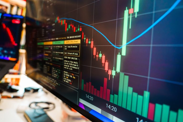 Stock image of candle charts on a monitor.