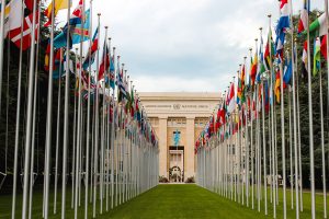 View of the United Nations Office in Geneva adorned with flags of various countries.